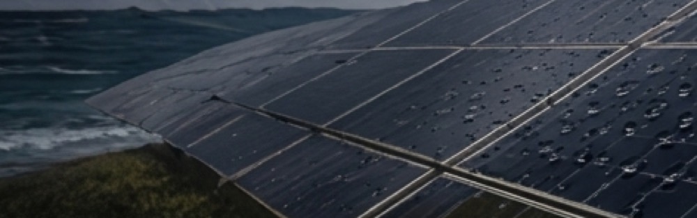 Solar panels beside the ocean with water droplets on the glass