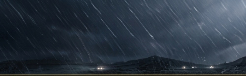 Heavy rain falling over a coastal solar installation at night